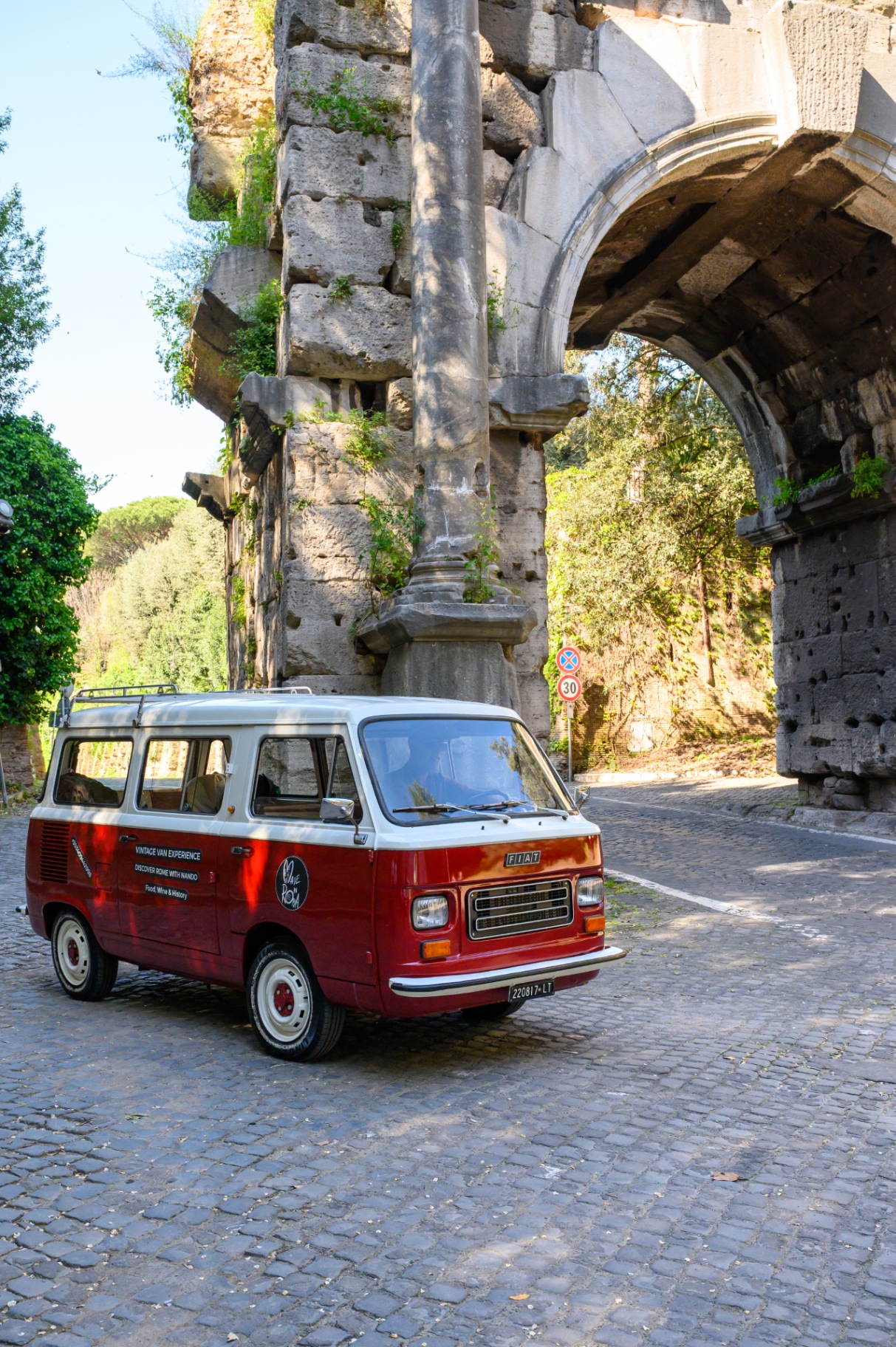 Nando parked beneath an ancient archway along the Appian Way